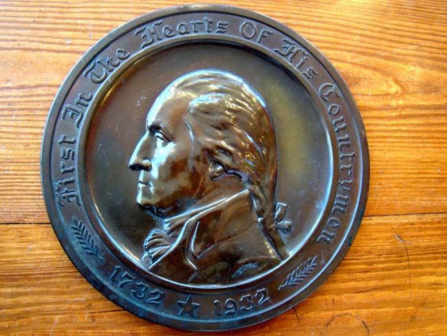 A deeply patinated brass plaque commemorating the Bicentennial of George Washington's birth 1732-1932